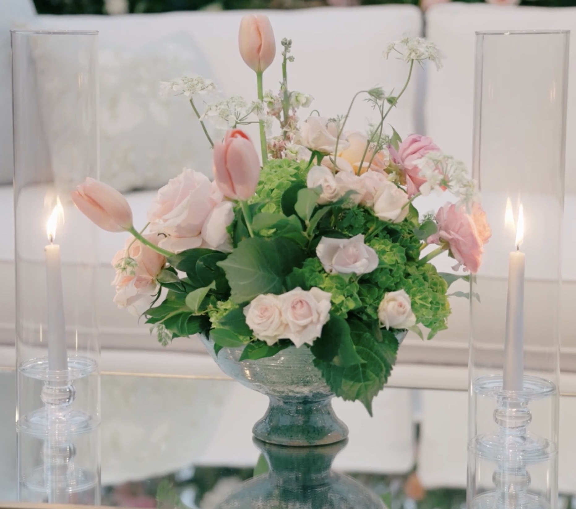 Floral centerpiece — roses, tulips, hydrangea with glass candle holders